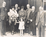 Group photo showing Dame Violet Wills (holding flowers)