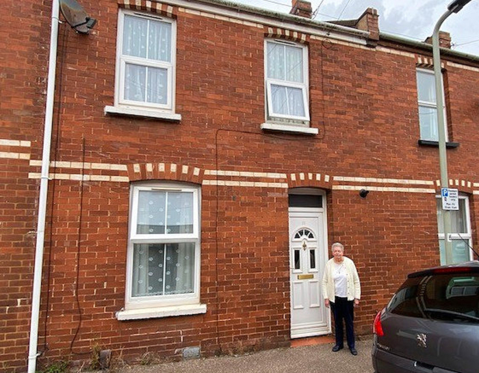 Sue Jackson outside her family's home, 35 Victor Street